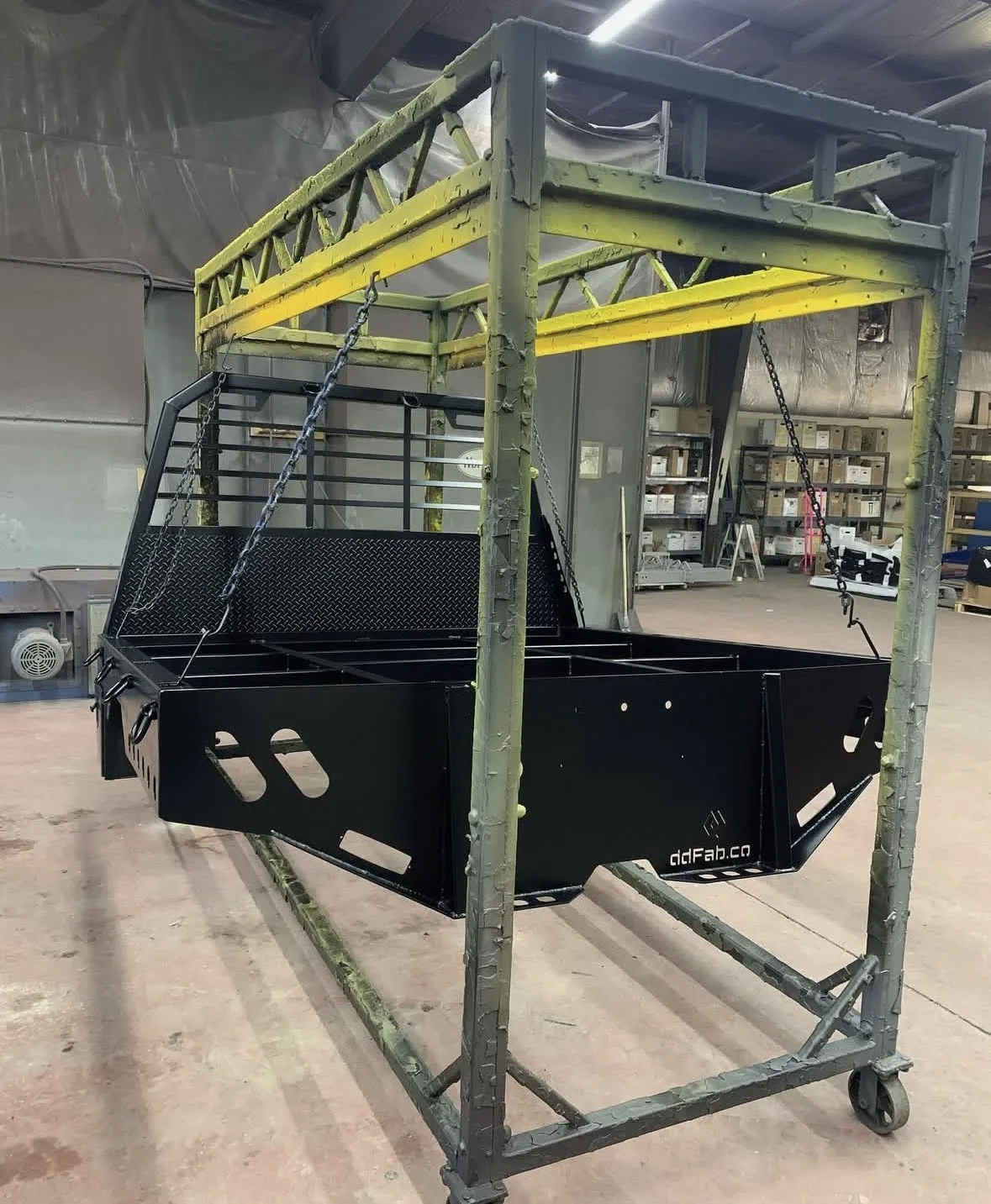 Large black and yellow powder-coated fabricated equipment frame in the shop
