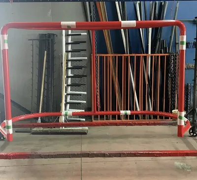 Red and white powder-coated tubular safety barrier in the Clark's shop