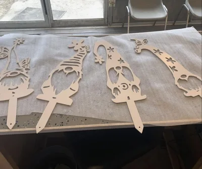 Bare decorative gnome-shaped metal cutouts before finishing