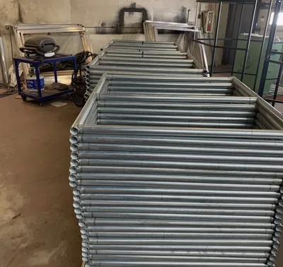 Stacks of bare tubular metal frames awaiting finishing