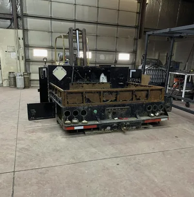 Large weathered industrial equipment body before refinishing