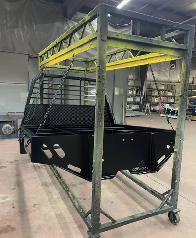 Large black and yellow powder-coated fabricated equipment frame in the shop