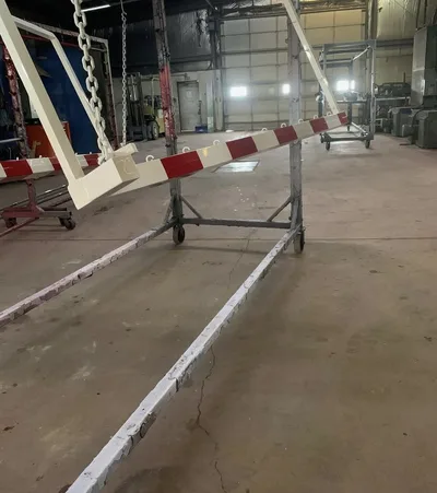 Red and white striped metal barrier arms during shop finishing