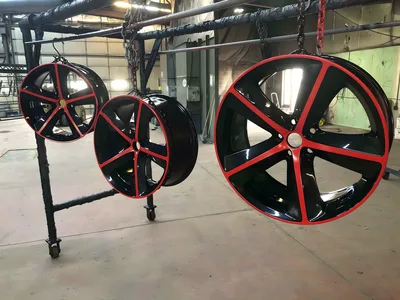 Black wheels with red accents hanging from racks in the Clark's shop