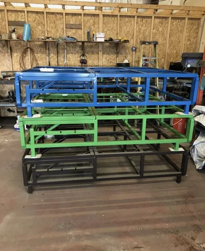 Finished fabricated frames stacked in blue, green and black