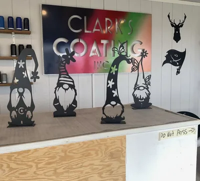 Clark's Coating shop display with branded sign and finished decorative gnomes