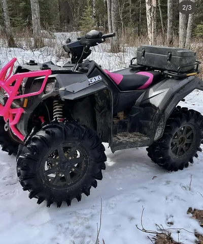 ATV outdoors with vivid pink powder-coated front rack and trim