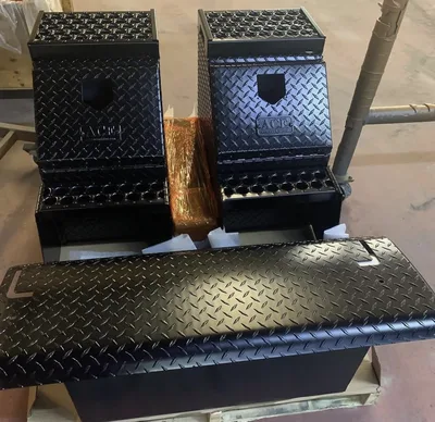 Black powder-coated diamond-plate fabricated boxes and step-like components